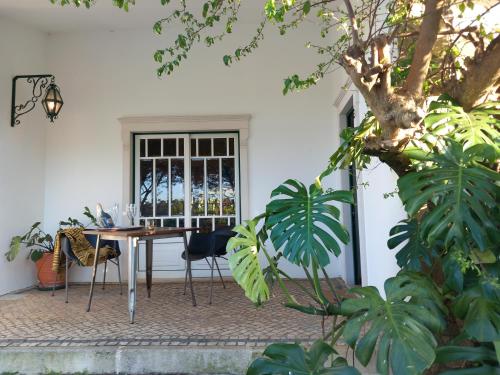 a patio with a table and chairs in front of a door at The Space - Central Portugal in Fungalvaz