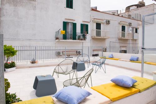 a patio with chairs and pillows on a roof at Dimora Cummà Marì in Vieste