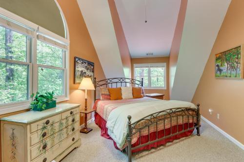 a bedroom with a bed and a window at Private Cartecay River Home with Hot Tub and Game Room in Ellijay
