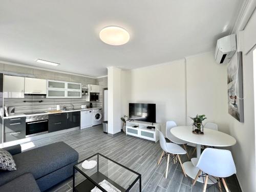 a living room with a couch and a table at Quarteira Ocean Breeze 1 With Pool by Homing in Quarteira