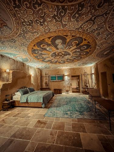 a bedroom with a bed in a room with a ceiling at Cappadocia Vita Cave Hotel in Urgup