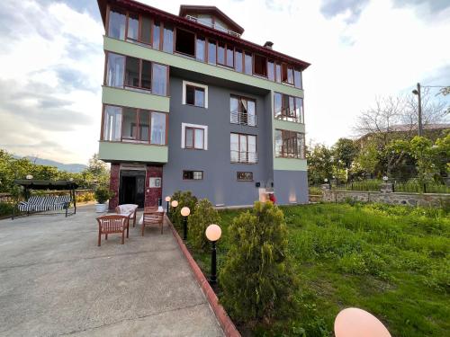 a building with a table and chairs in front of it at Shen Home Life in Trabzon