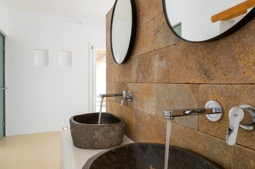 a bathroom with a sink and a mirror at Anna Platanou Suites in Agia Irini Paros