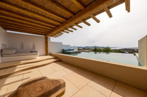 a balcony with a view of a swimming pool at Anna Platanou Suites in Agia Irini Paros