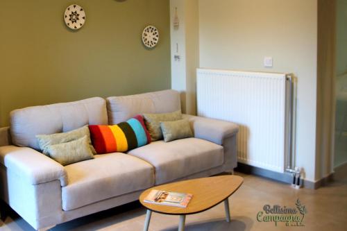 a living room with a couch with colorful pillows at Bellisima Campagna Cabin Pelekapina - Chania Crete in Chania Town