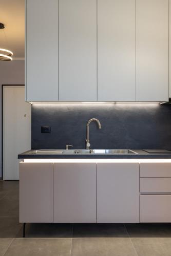 a kitchen with white cabinets and a sink at The view vanilla, Free Parking in Sarandë