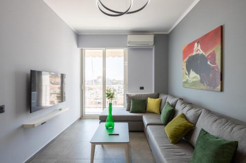 a living room with a couch and a tv at The view4- "Free Parking" in Sarandë