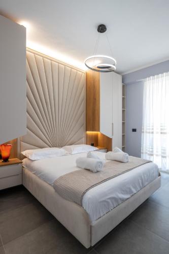a bedroom with a large bed with two towels on it at The view vanilla, Free Parking in Sarandë