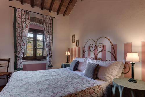 a bedroom with a large bed and a window at Agriturismo Nobile in Montepulciano