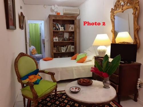1 dormitorio con cama, espejo y silla en TERRASSE DU PITON, en Deshaies