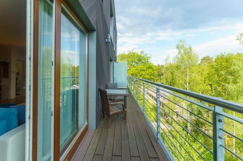 a balcony of a house with a desk on it at Golden Dune 100m od plaży in Międzyzdroje