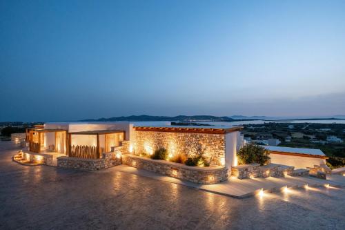 a building with lights on it at night at Anna Platanou Suites in Agia Irini Paros
