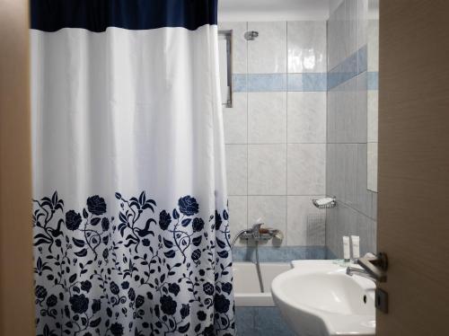 a bathroom with a black and white shower curtain at Home Sweet Home Unique Sea View in Sivota