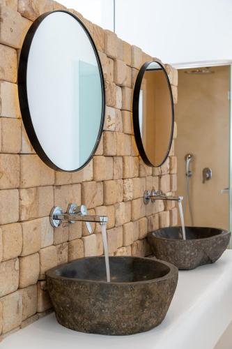a bathroom with two sinks and a mirror at Anna Platanou Suites in Agia Irini Paros