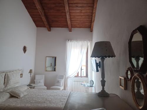 a bedroom with a bed and a mirror and a lamp at CASA RE.ALE in Viterbo