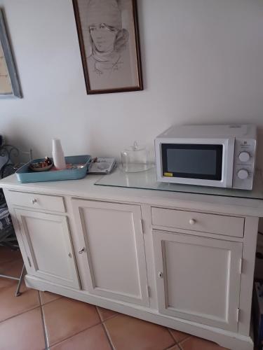 a white counter with a microwave on top of it at CASA RE.ALE in Viterbo