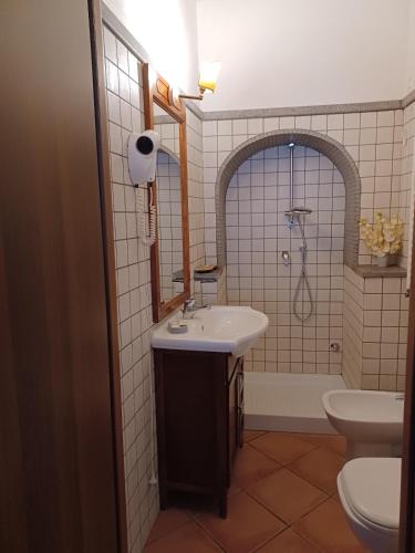 a bathroom with a sink and a toilet at CASA RE.ALE in Viterbo