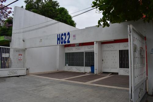 a white building with two gates in front of it at Hostel Cuartos de Renta Nuevos Huasteca Potosina WIFI A/C in Ciudad Valles