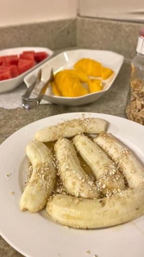 a plate of food with bananas on a table at Hotel Mendes Azevedo in Goiânia