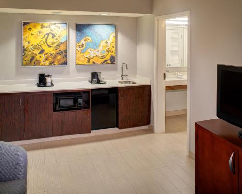 a kitchen with a sink and a microwave at Courtyard by Marriott Columbia Northeast/Fort Jackson Area in Columbia