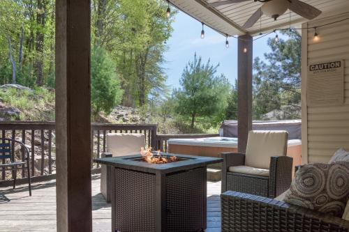 a patio with a fire pit on a deck at 6 Fieldstone Ct in Lake Harmony