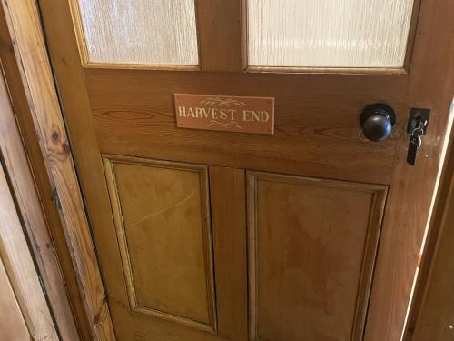 eine Holztür mit einem Gefahrenendschild darauf in der Unterkunft Harvest End in York
