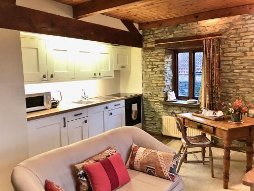 a living room with a couch and a table in a kitchen at Harvest End in York
