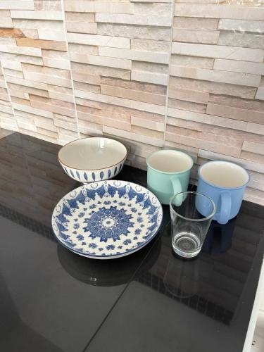 a table with three bowls and a plate and a glass at Impact Arena C3 Milo in Nonthaburi
