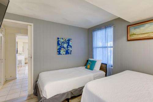two beds in a small room with a window at 2 Blocks to Bay Cabana Breeze Rockport Rental! in Rockport