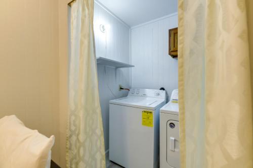 a small kitchen with a washing machine and a shower curtain at 2 Blocks to Bay Cabana Breeze Rockport Rental! in Rockport