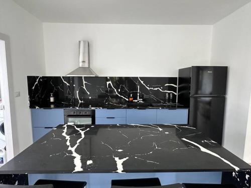 a kitchen with a black and white counter top at 2-bd apartment at the heart of the Carmel in Haifa