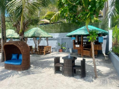 a resort patio with chairs and tables and umbrellas at The Philip Ann Resort in Mabini