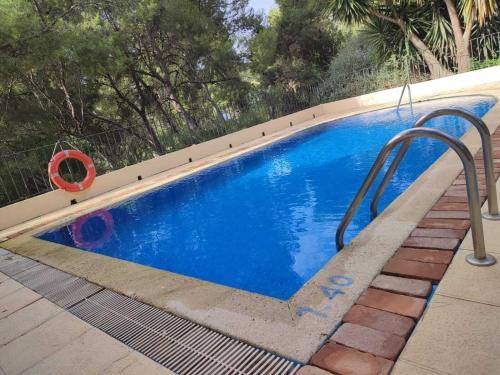 a small blue swimming pool with a metal hand rail at Hotel La Mariposa in Alhama de Murcia