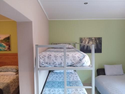 a room with two bunk beds and a bed at SONHOS dreams Self catering Garden Cottages in Bloemfontein