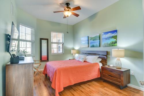 a bedroom with a bed and a ceiling fan at Coastal Condo with Harbor Views Steps to Beach! in Clearwater Beach