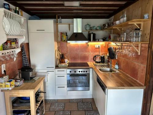 a small kitchen with a sink and a stove at VillaVoigt, een Gezellig Familiehuis in Äussere Kainisch