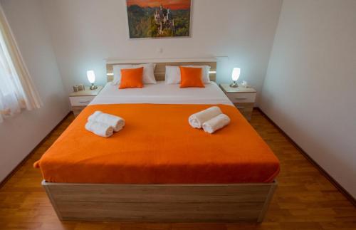 a bedroom with a large bed with two towels at Apartman Domenika in Makarska
