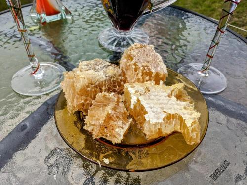 a plate of food on a table with glasses of wine at 4 seasons. 4 სეზონი Glamping Georgia Racha in Ambrolauri