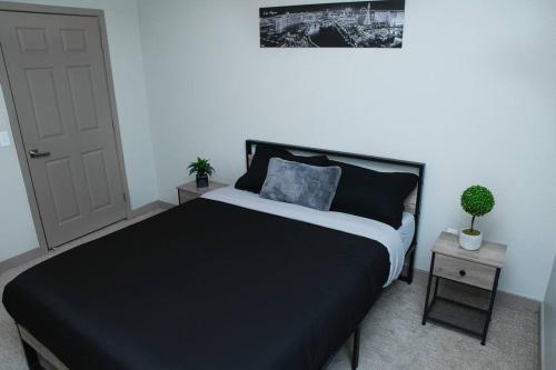 a bedroom with a black bed and a white door at Beautiful TownHome With Garage in Las Vegas in Las Vegas