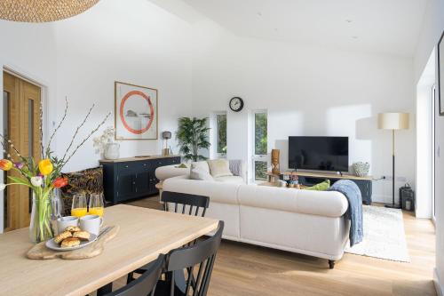 a living room with a white couch and a table at The Hideaway, Modern 3 bed in Tintagel, Cornwall in Tintagel