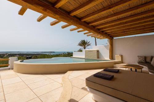 a villa with a swimming pool and a living room at Utopia Suites by Anna Platanou in Agia Irini Paros
