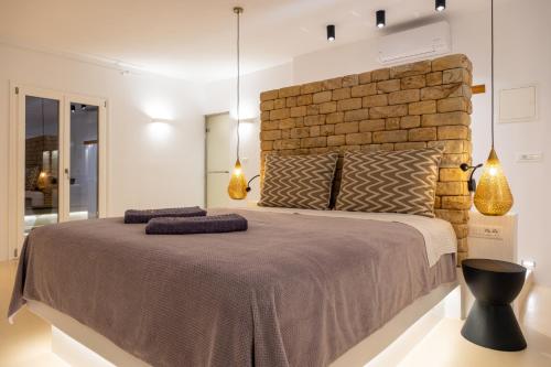 Ένα ή περισσότερα κρεβάτια σε δωμάτιο στο Utopia Suites by Anna Platanou