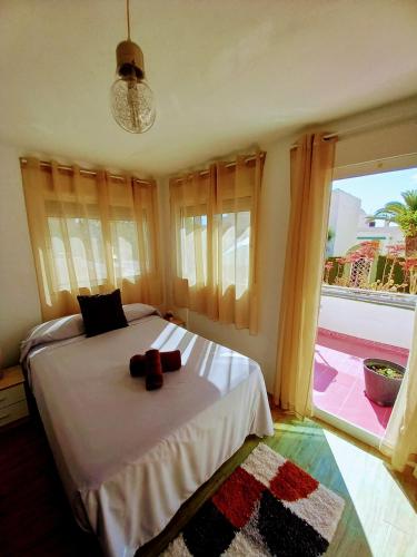 a bedroom with a bed and a large window at Casa Bart de vacaciones in Mazarrón
