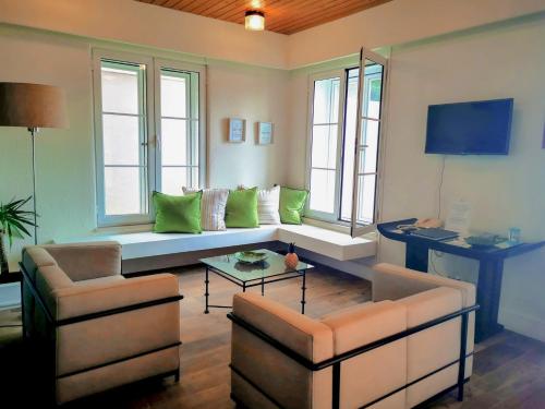 a living room with a couch and two chairs at Garden's Nest - North Villa in Conceição