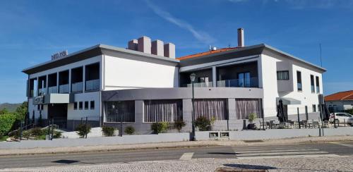 a large white building on the side of a street at Villa Rey Spa & Hotel in Vila de Rei