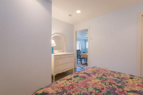 a bedroom with a bed and a dresser and a mirror at 83 Sagamore Road Sagamore Beach - - Cape Cod in Bourne