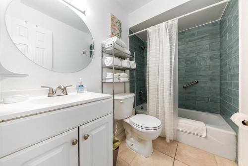 La salle de bains est pourvue d'un lavabo, de toilettes et d'un miroir. dans l'établissement Beach Villa A, à Clearwater Beach