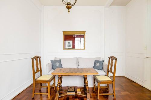 a table and chairs in a room with white walls at A Friendly Room in the Heart of Recoleta -in Shared Apartment- in Buenos Aires
