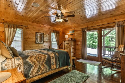 a log cabin bedroom with a bed and a ceiling fan at The High Life LONG RANGE VIEWS OF THE BLUE RIDGE MOUNTAINS in Mineral Bluff
