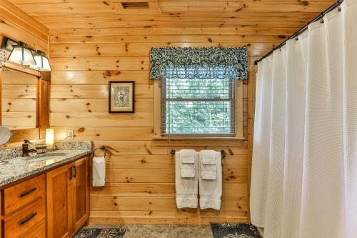 a log cabin bathroom with a shower and a window at The High Life LONG RANGE VIEWS OF THE BLUE RIDGE MOUNTAINS in Mineral Bluff